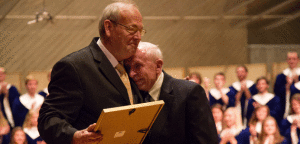 Bruce Tammen, receiving an award from his mentor Weston Noble at Luther College
