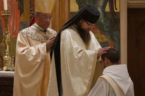 Fr. Hilarion laying on his hands.