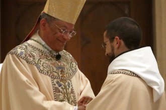 Bishop Perry offers the newly-ordained Fr. Timothy the Sign of Peace.